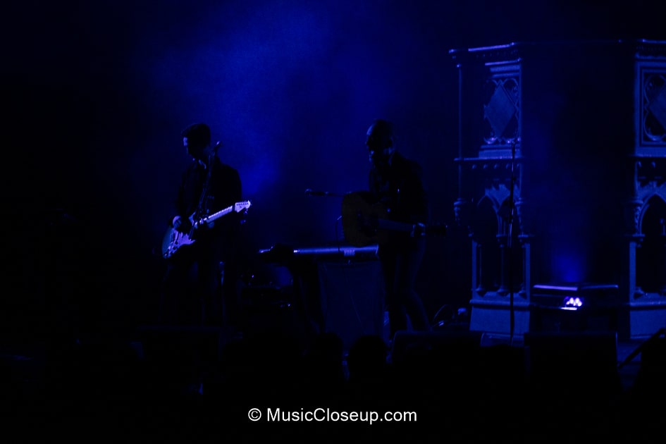 Dave and Tim Hause in silhouette shrouded in blue light