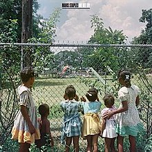 Black school girls staring through a fence