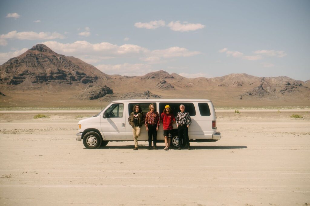 The band Carpool Tunnel outside a minibus in the desert