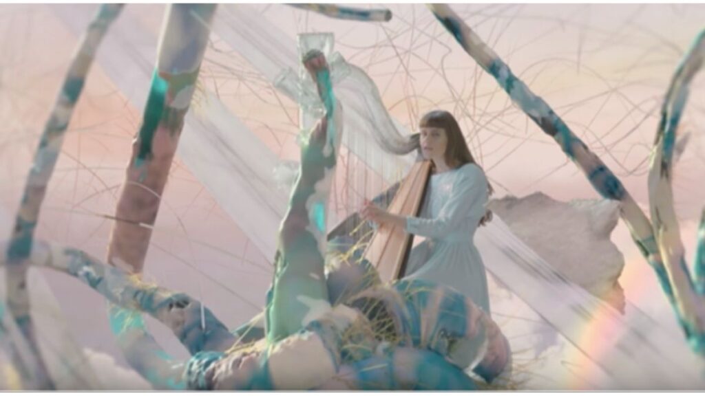 Emilie Kahn Three still photo = playing harp