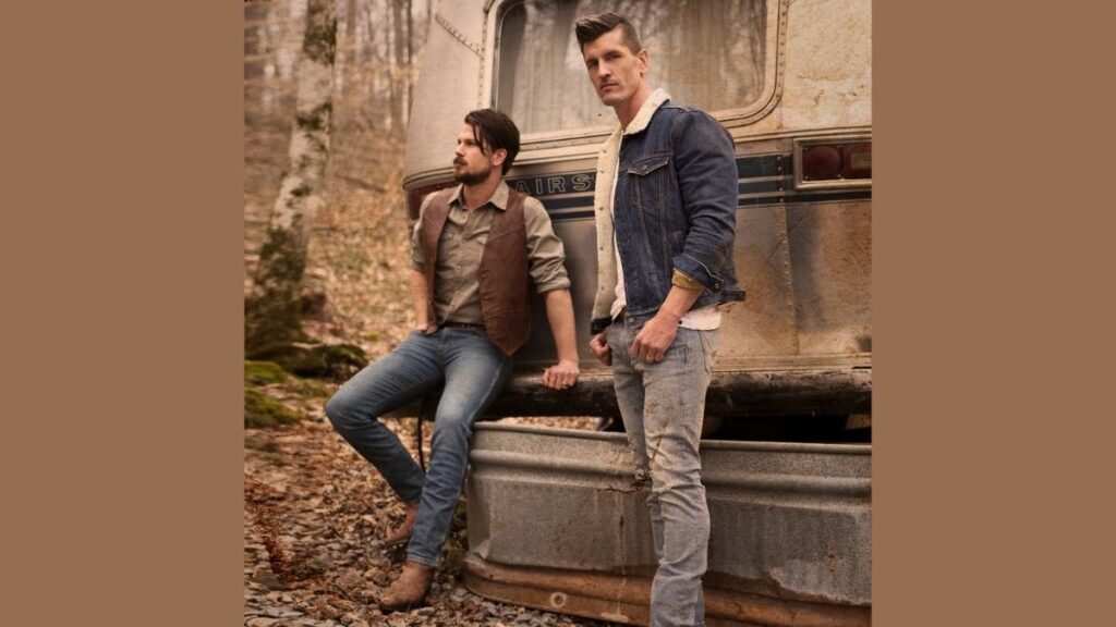 High Valley brothers leaning on a caravan