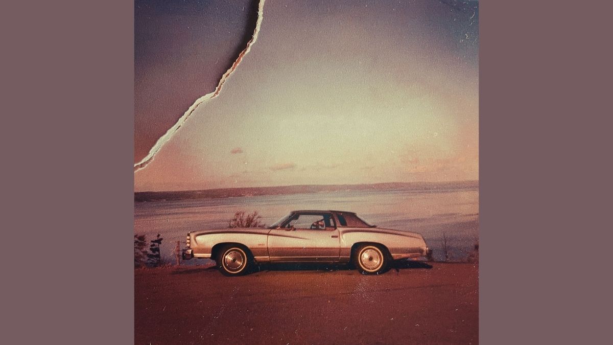 A 1977 Monte Carlo car in a torn, old photograph