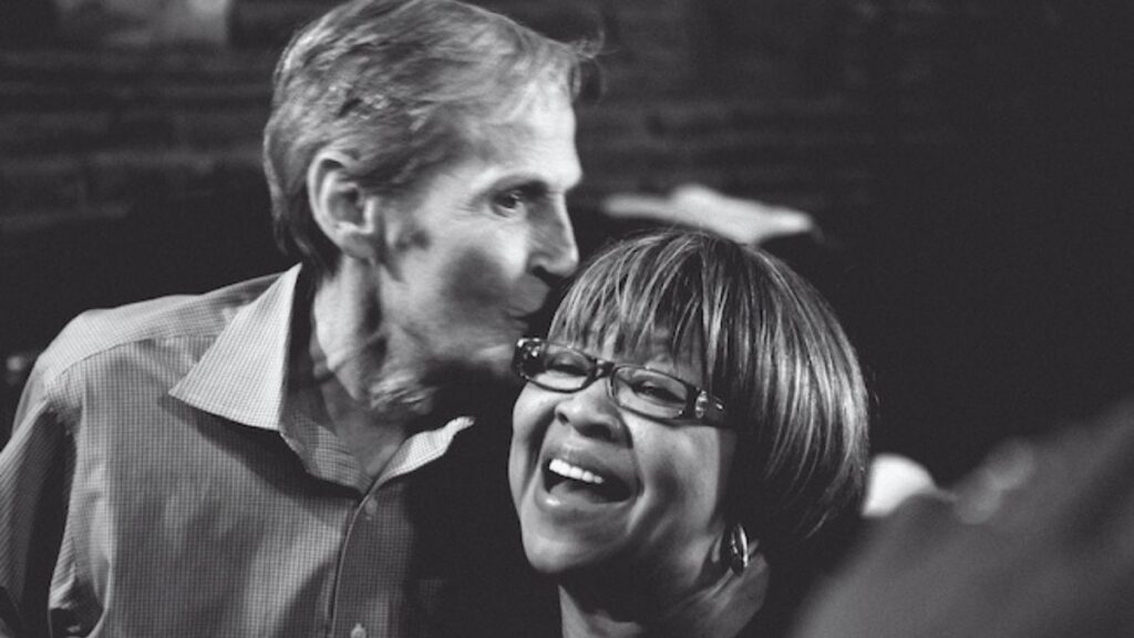 Mavis Staples cover: Levon Helm kissing Mavis Staples on the head