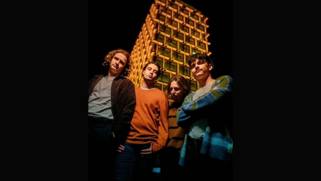 The Faim in front of a lit up building