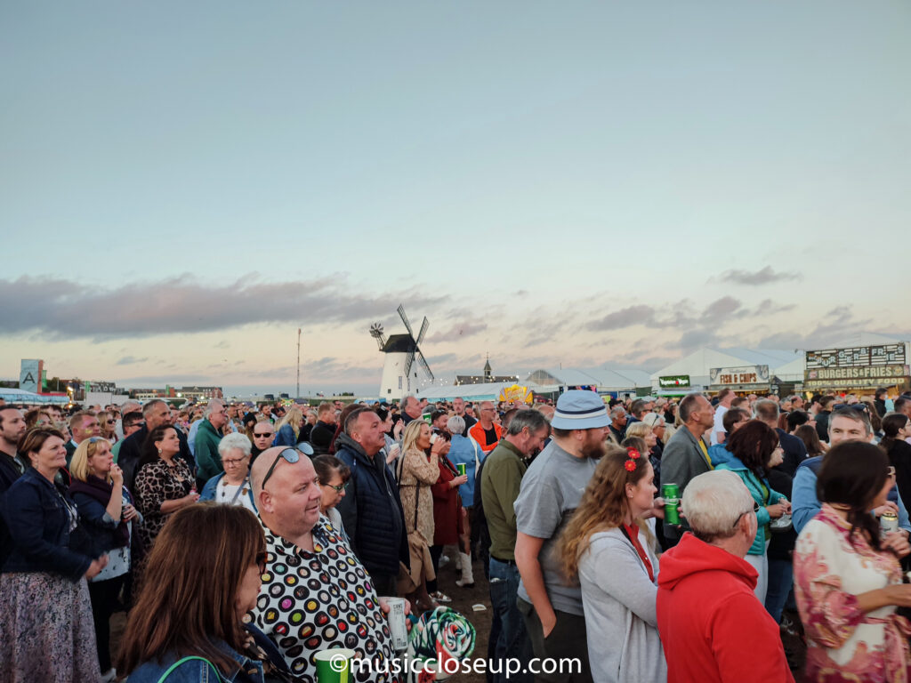 Crowd at Lytham Festival with windmill in the background