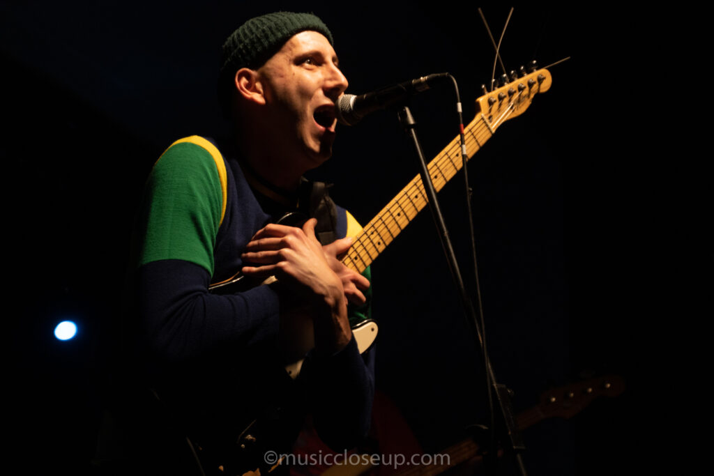 Eugene Gaine from Dubinski hugging an electric guitar