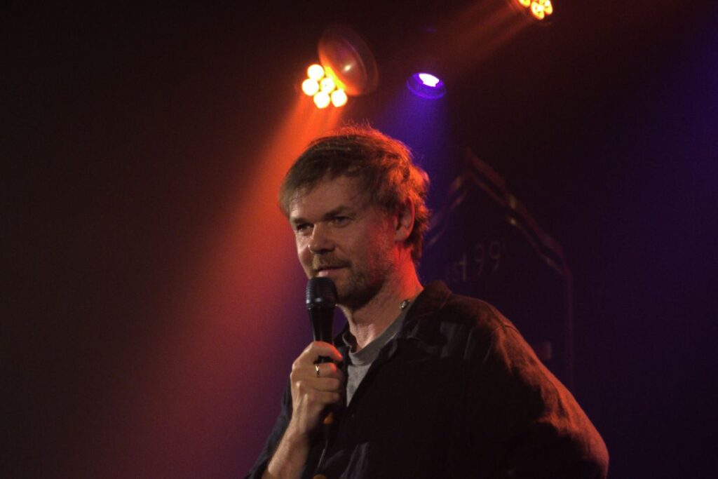 Idlewild frontman Roddy Woomble live in Dumfries, speaking into a microphone