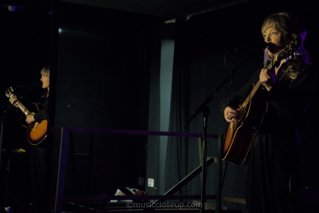 Emily Barker performing live in Dumfries, reflected in the mirror on stage