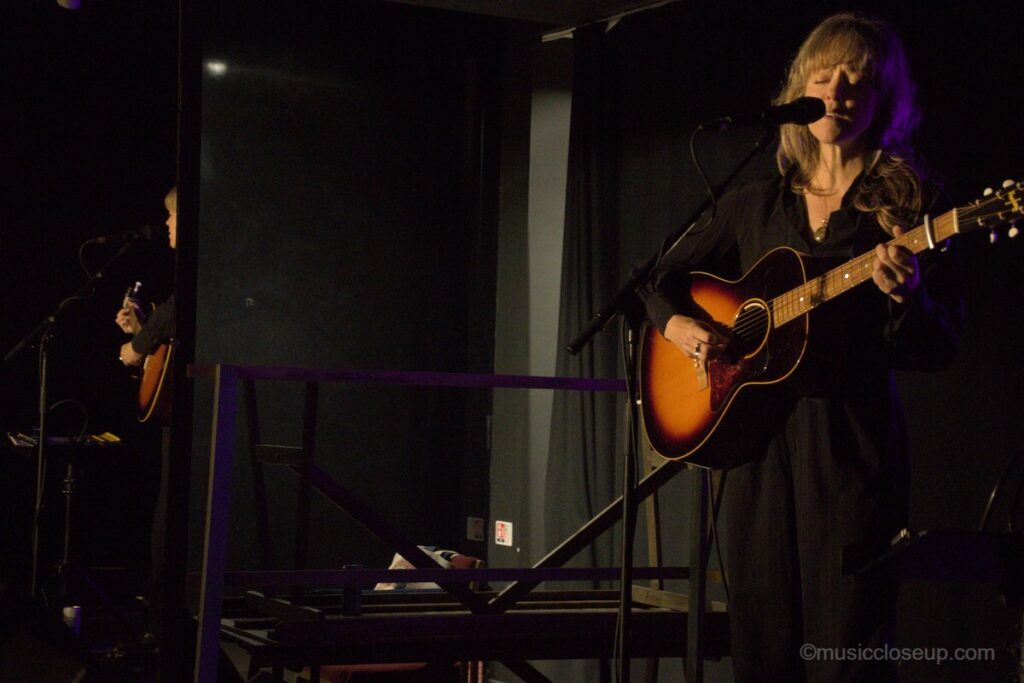 Emily Barker live in Dumfries: playing guitar with a mirrored reflection visible too
