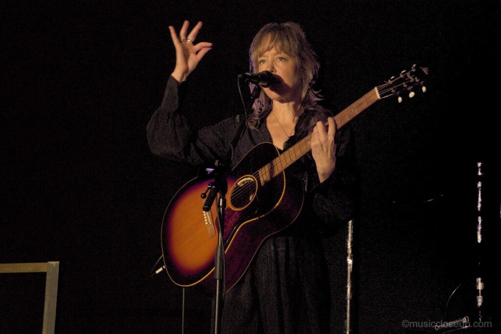 Emily Barker live in Dumfries making the OK sign