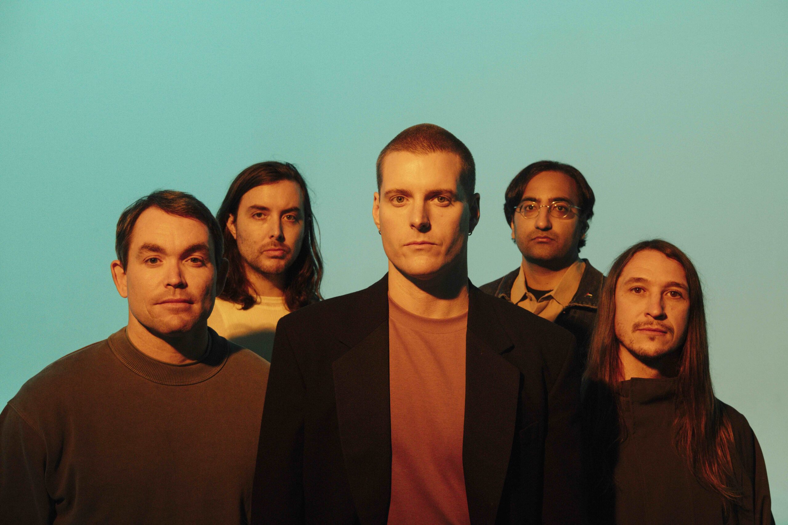 The band Deafheaven against a mint green background