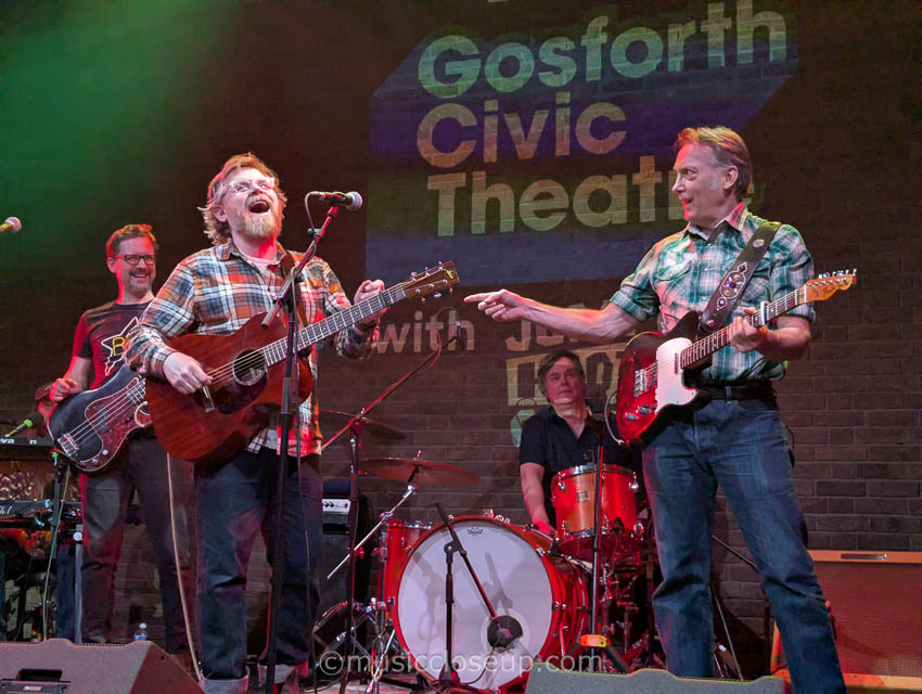 Danny and the Champions of the World live: Guitarist Paul Lush pointing in surprise at Danny George Wilson who is laughing