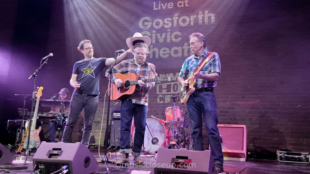 Danny and the Champions of the World live: Joe Bennett placing a cowboy hat on Danny George Wilson's head