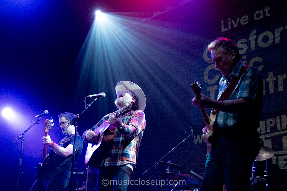 Danny and the Champions of the World live: Danny singing passionately with a spotlight shining on him
