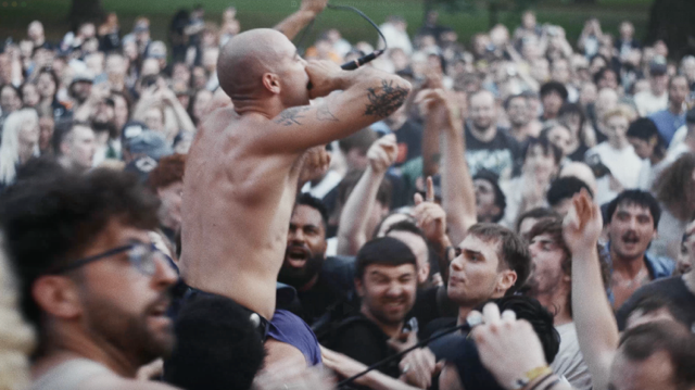 Show Me The Body cover Sabotage: Show Me The Body cover Sabotage performs shirtless at a festival, reaching out into the crowd