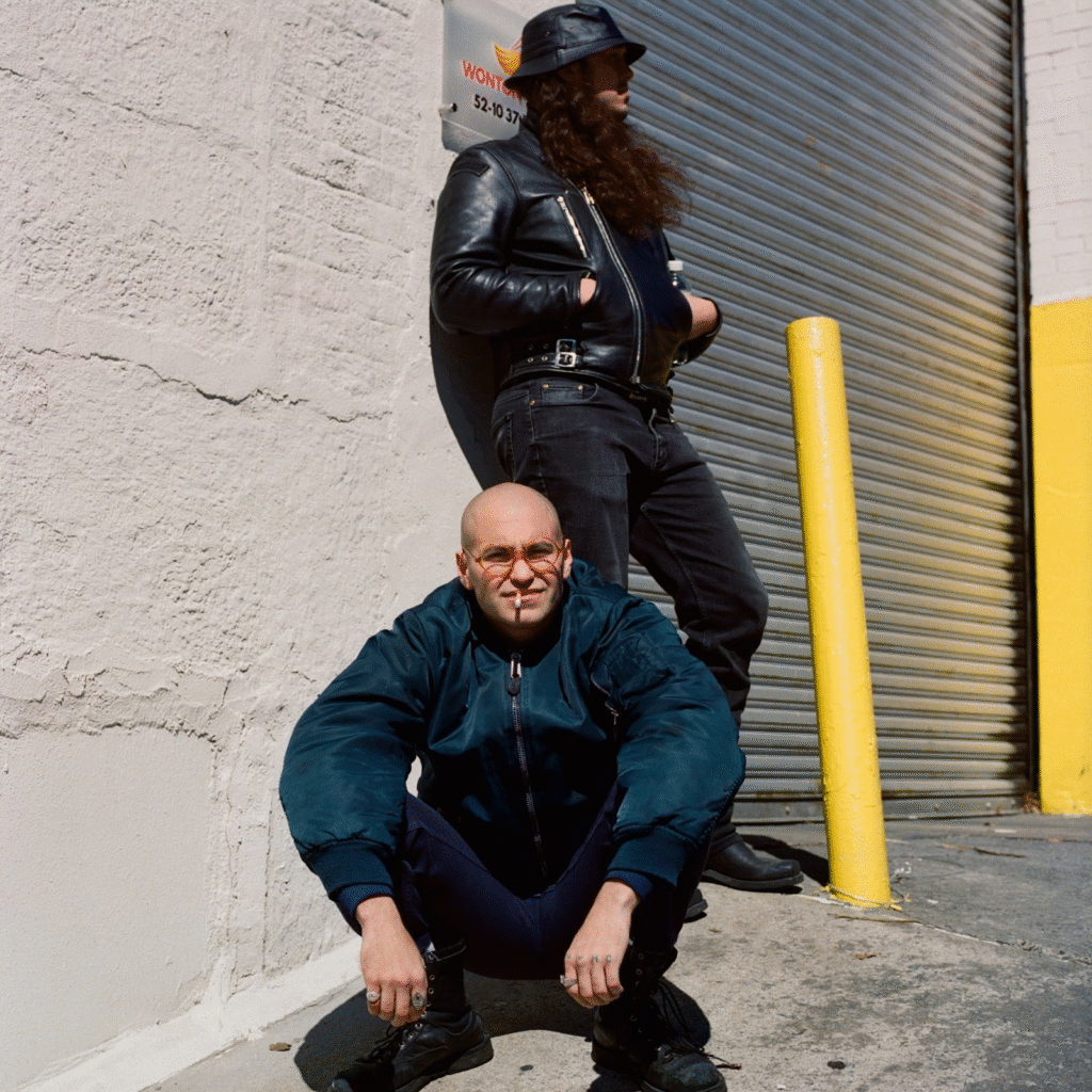 Show Me The Body cover Sabotage; press photo showing bassist Harlan steed wearing a leather jacket and Julian Cashwan Pratt crouching, looking straight at the camera
